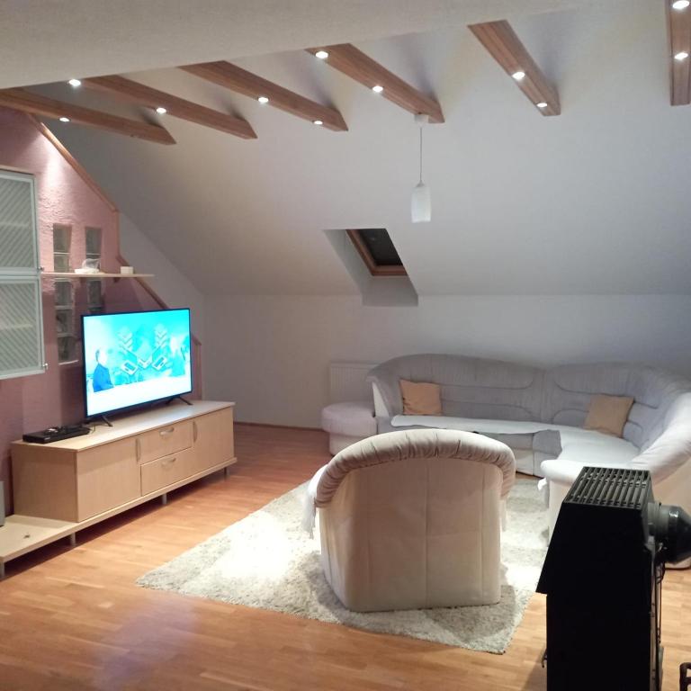 a living room with a couch and a tv at Petra in Livno