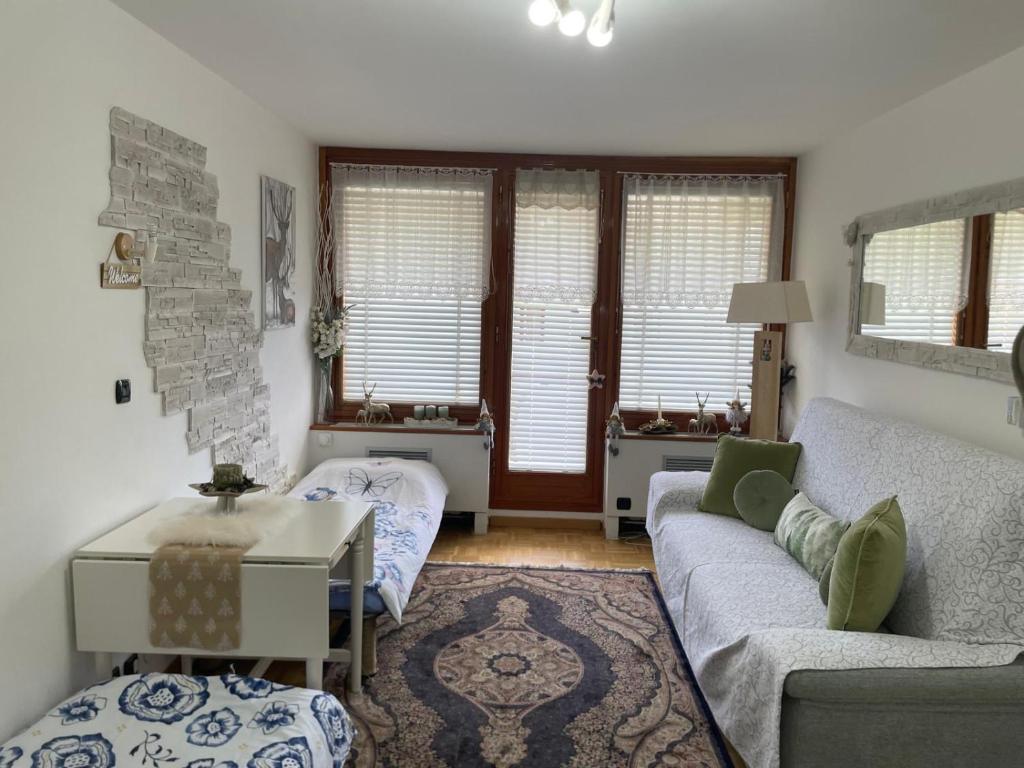 a living room with a couch and a table at Condominio - Guglielmo Tell in Sestriere