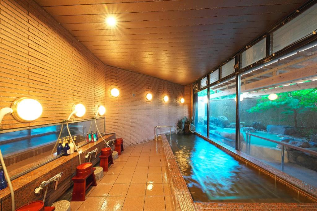 a large indoor swimming pool in a building at Hotel Hanaan in Nikko