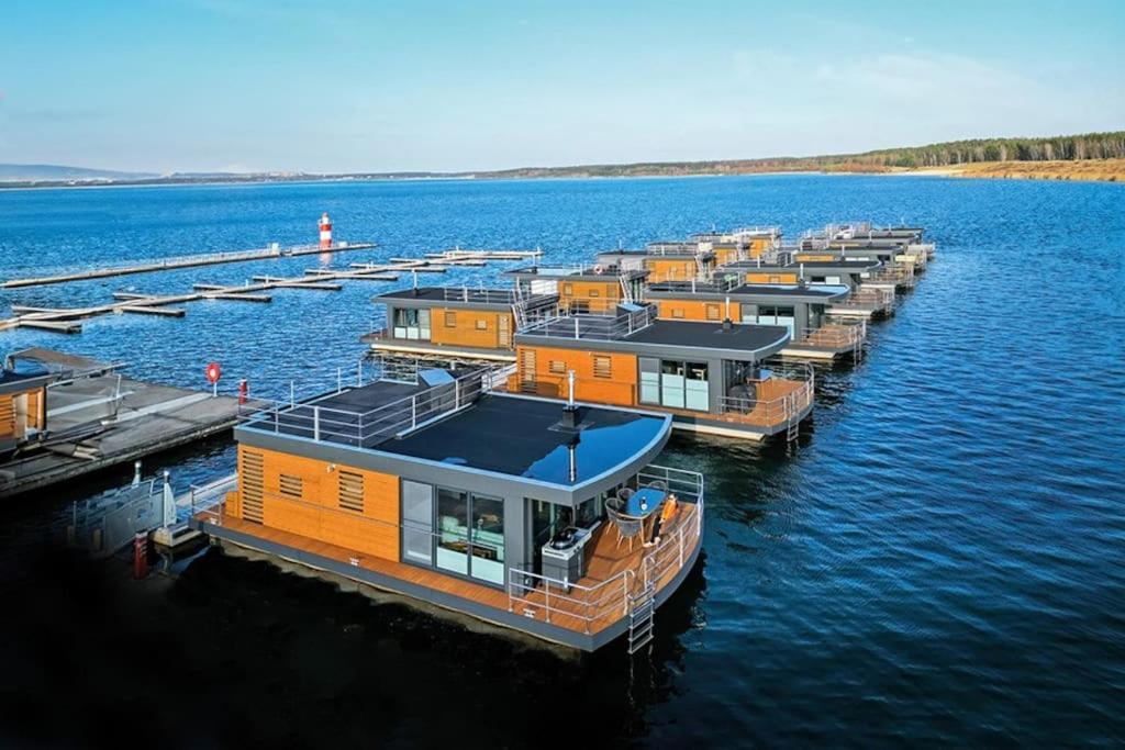 a row of houses on a dock in the water at Hausboot Bellini in Klitten