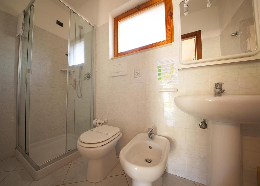 a bathroom with a toilet and a sink and a shower at Hotel Danila in Portoferraio