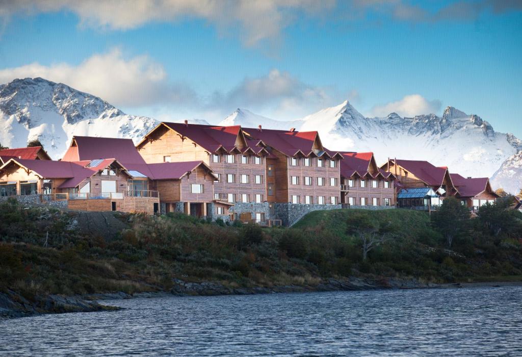 a large building with a view of the ocean and mountains at Los Cauquenes Resort + Spa + Experiences in Ushuaia