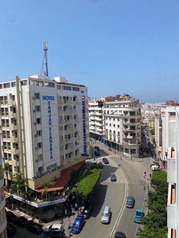 a building with a hotel sign on the top of it at Dar sam in Tangier