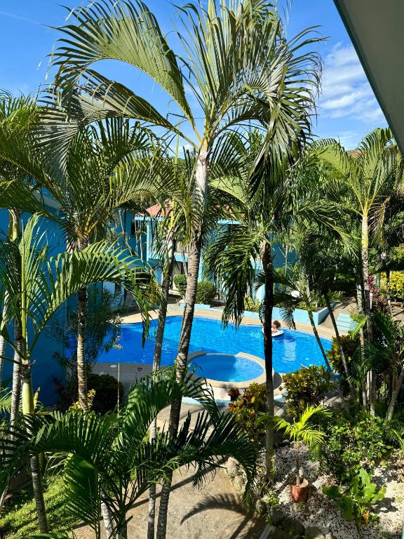 a view of a resort with palm trees and a pool at Coco Maya 2b2b Villa in Coco
