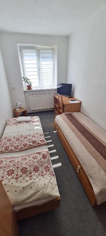 Postel nebo postele na pokoji v ubytování Penzión Borievka