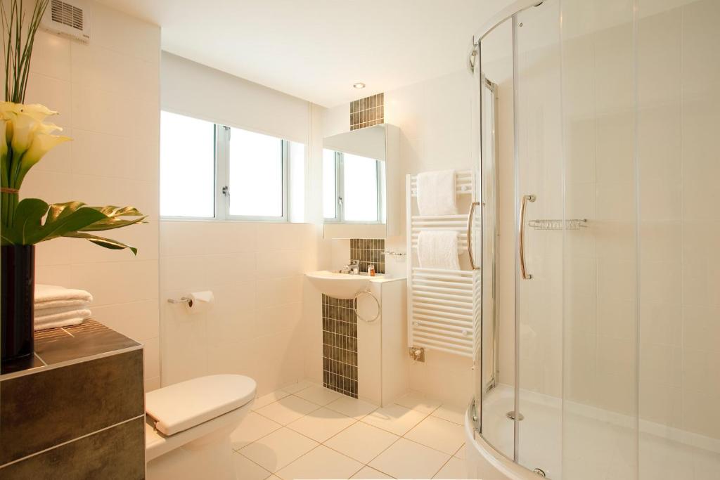 a bathroom with a shower and a toilet and a sink at SACO Holborn – Lamb’s Conduit St in London