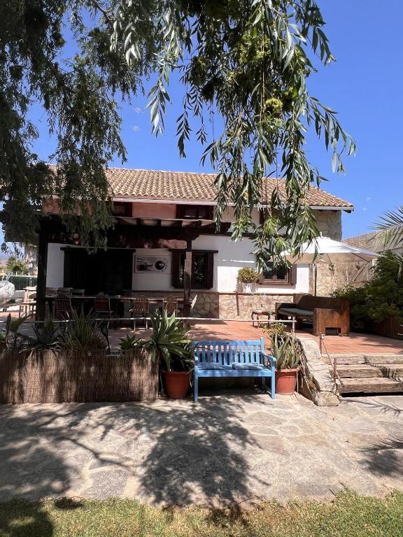 a blue bench in front of a house at Kite House Tarifa in Tarifa