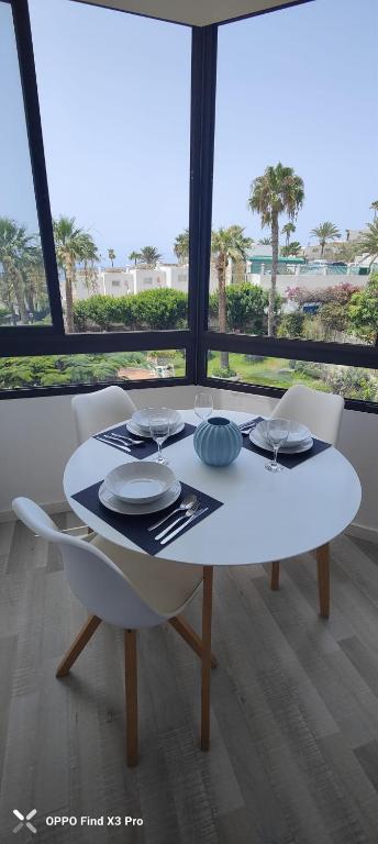 a white table with plates on it in a room at Sunrise Apartamentos in San Bartolomé