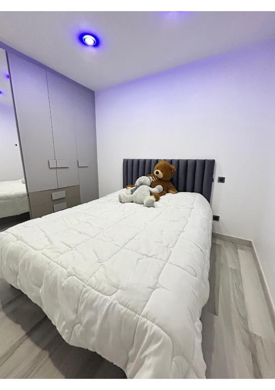 - un ours en peluche assis sur un lit dans une chambre dans l'établissement Villa prestige, à Florensac