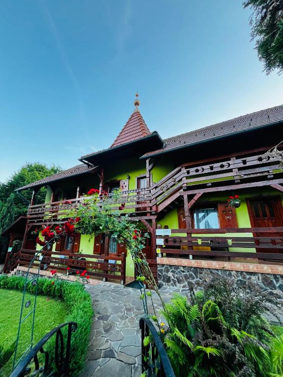 a house with a yellow at Casa de vacanță Trei Zâne in Sovata