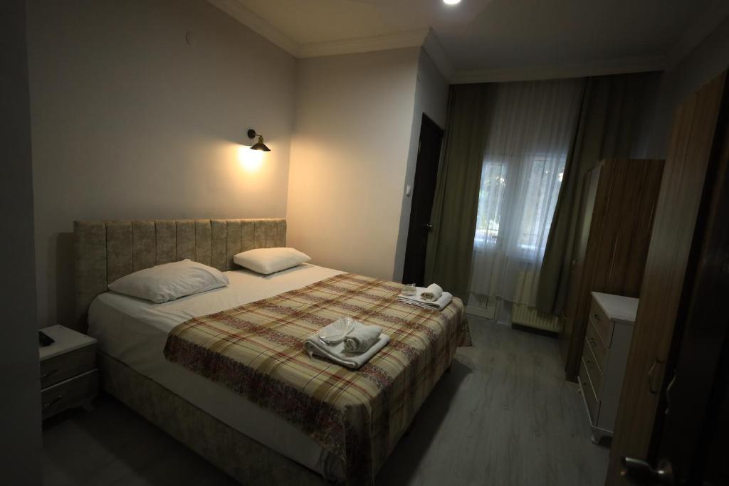 a hotel room with a bed with a towel on it at Hotel Cappa in Ürgüp