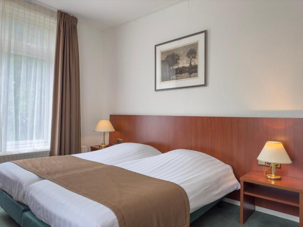 Postel nebo postele na pokoji v ubytování Hotel 't Spijker