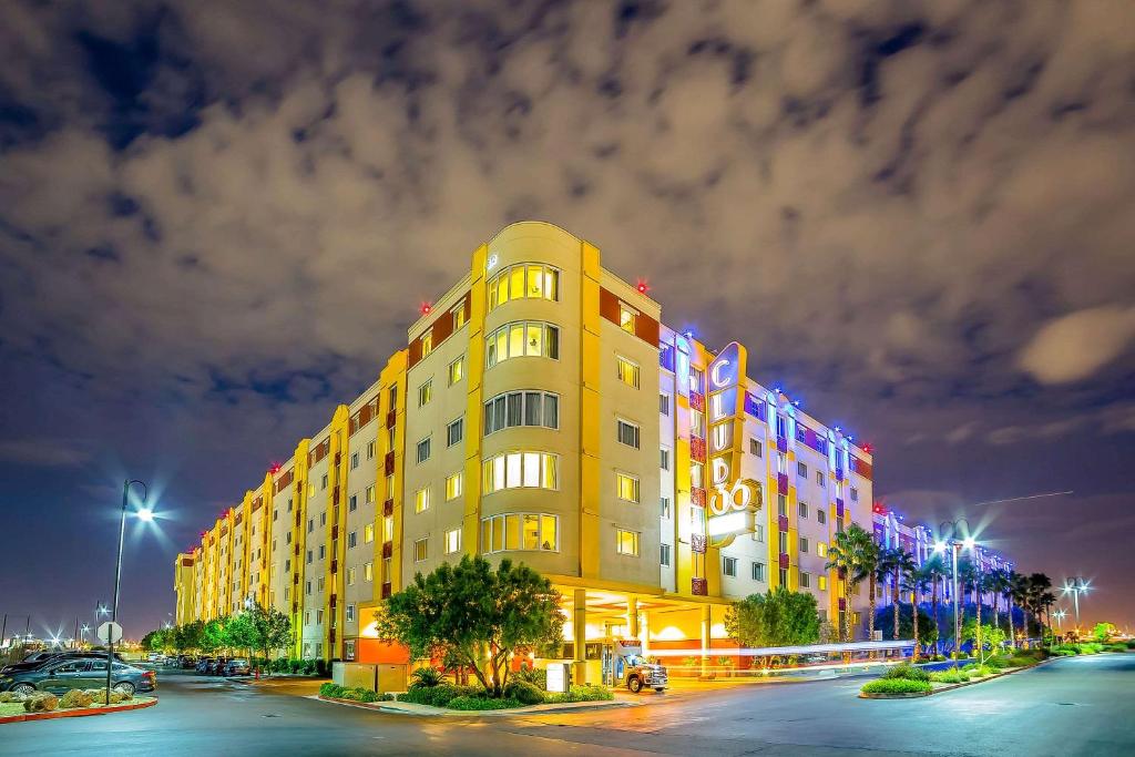 a large yellow building with colorful lights on it at Bluegreen Vacations Club 36, an Ascend Collection Resort in Las Vegas
