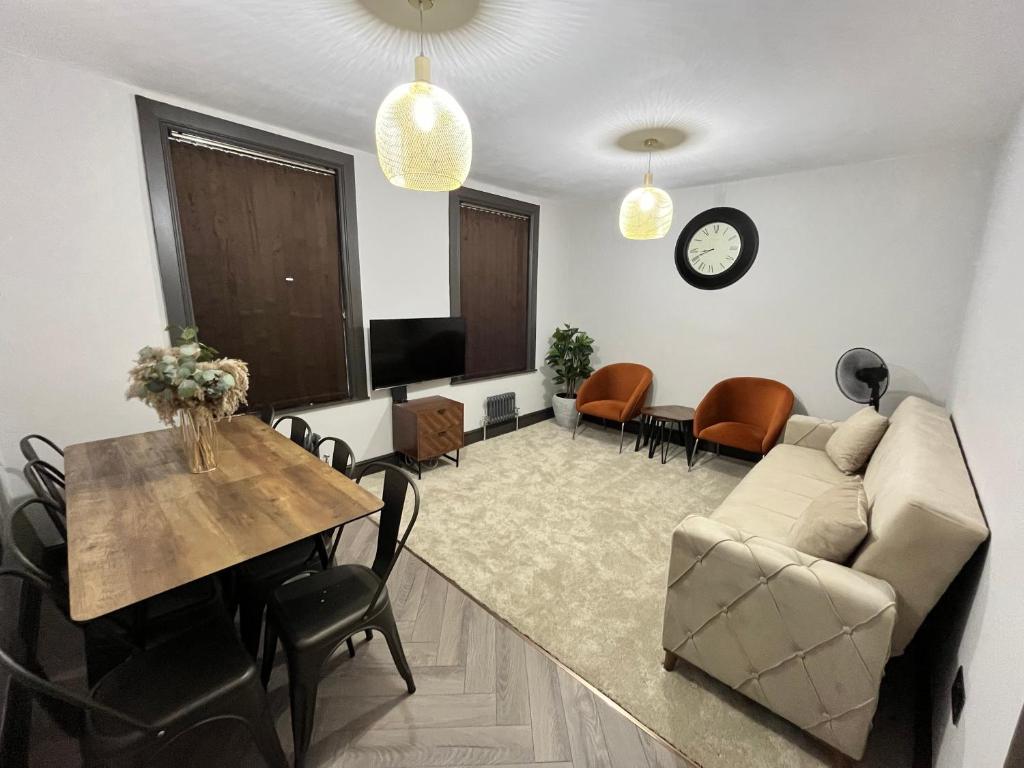 a living room with a couch and a table at Fabulous 3 Bed Apartment - Near Excel - Sleeps 6 - 8 in London