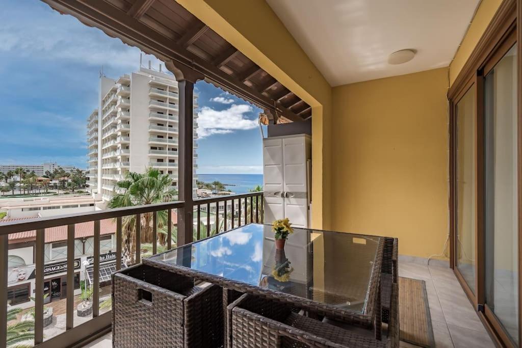 a balcony with a table and a view of the ocean at Loro Apt Playa de las Americas in Playa Fañabe
