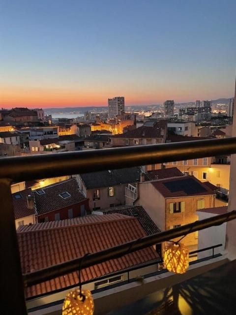d'un balcon offrant une vue sur la ville au coucher du soleil. dans l'établissement Endoume mon Amour, à Marseille