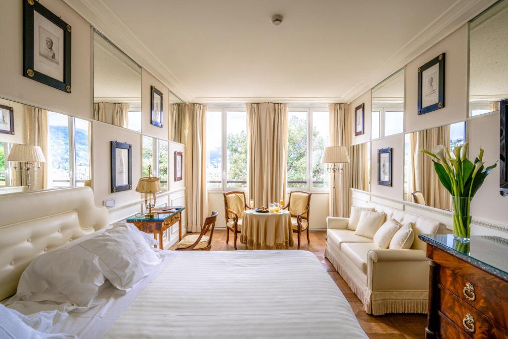 a bedroom with a bed and a living room at Excelsior Palace Portofino Coast in Rapallo