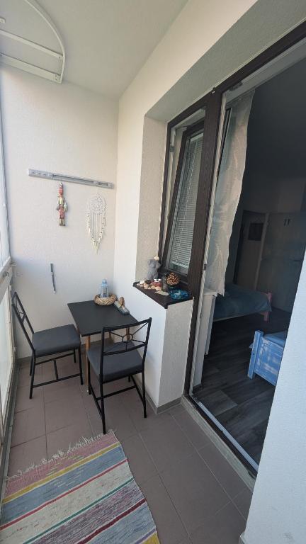a small room with a table and a balcony at Retro Art room in Lomnice nad Popelkou