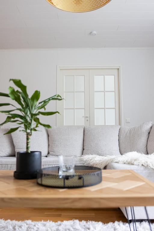 a living room with a couch and a coffee table at Aurora Row House in Rovaniemi