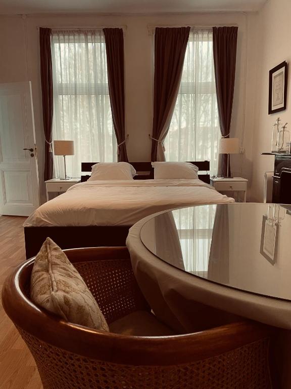 a bedroom with two beds and a large window at Bed and Breakfast Always Good in Utrecht