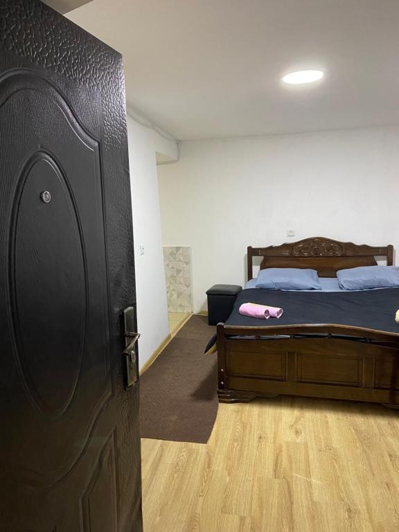 a bedroom with a bed and a wooden floor at Дом в старом тбилиси in Tbilisi City