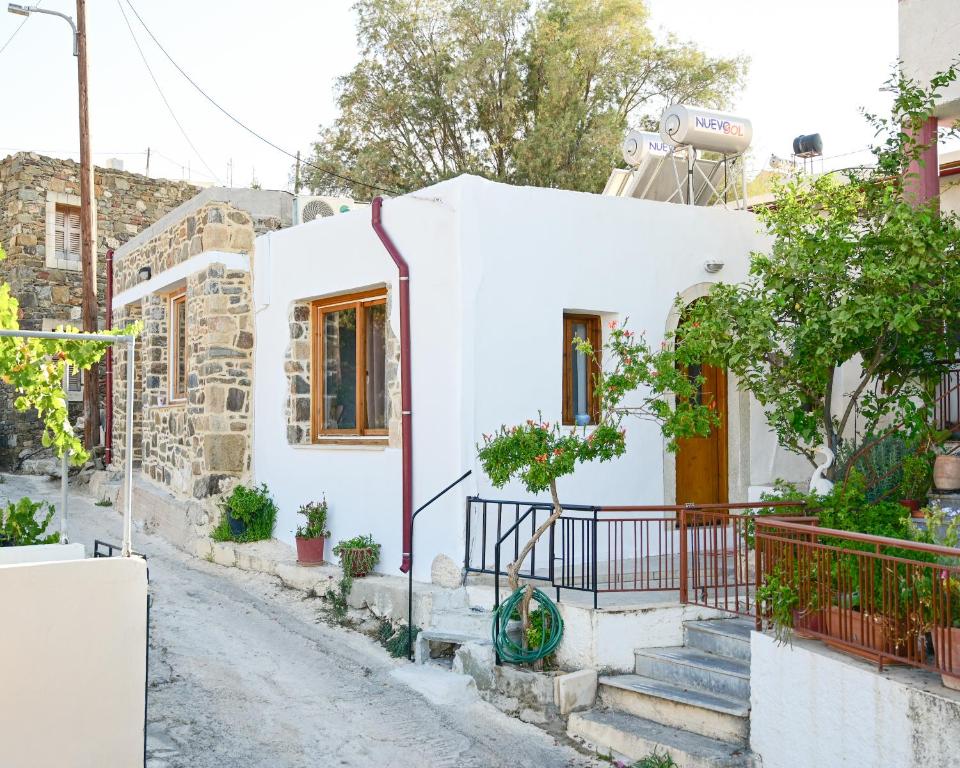 a white house with stairs leading up to it at Guest house Dimitra in Sitia