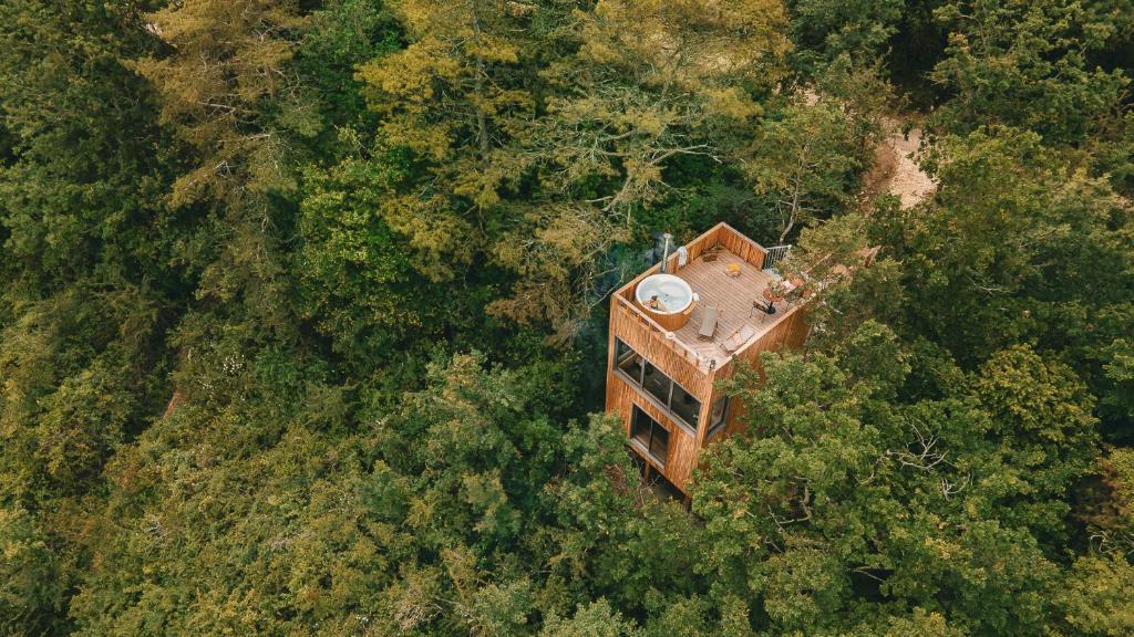 an overhead view of a building in the forest at Les Coteaux - Lodges & Expériences in Laparade