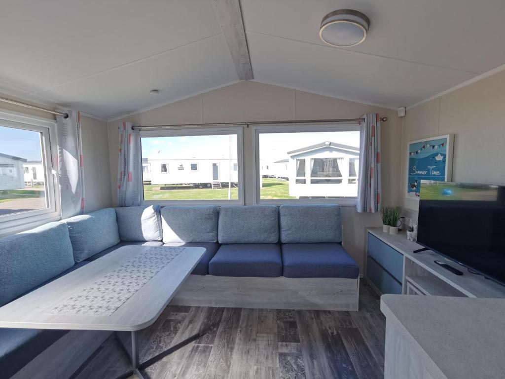 a living room with a couch and a tv at Golden Sands sea holiday beach activities and relax in Mablethorpe