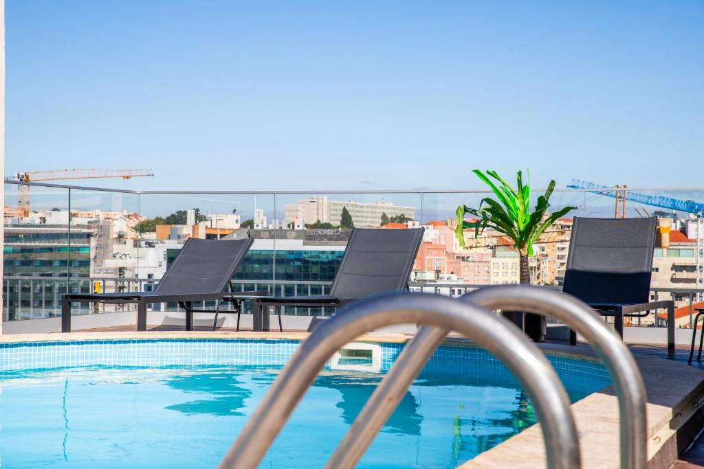 a view of a swimming pool on a building at VIP Executive Suites do Marquês Hotel in Lisbon
