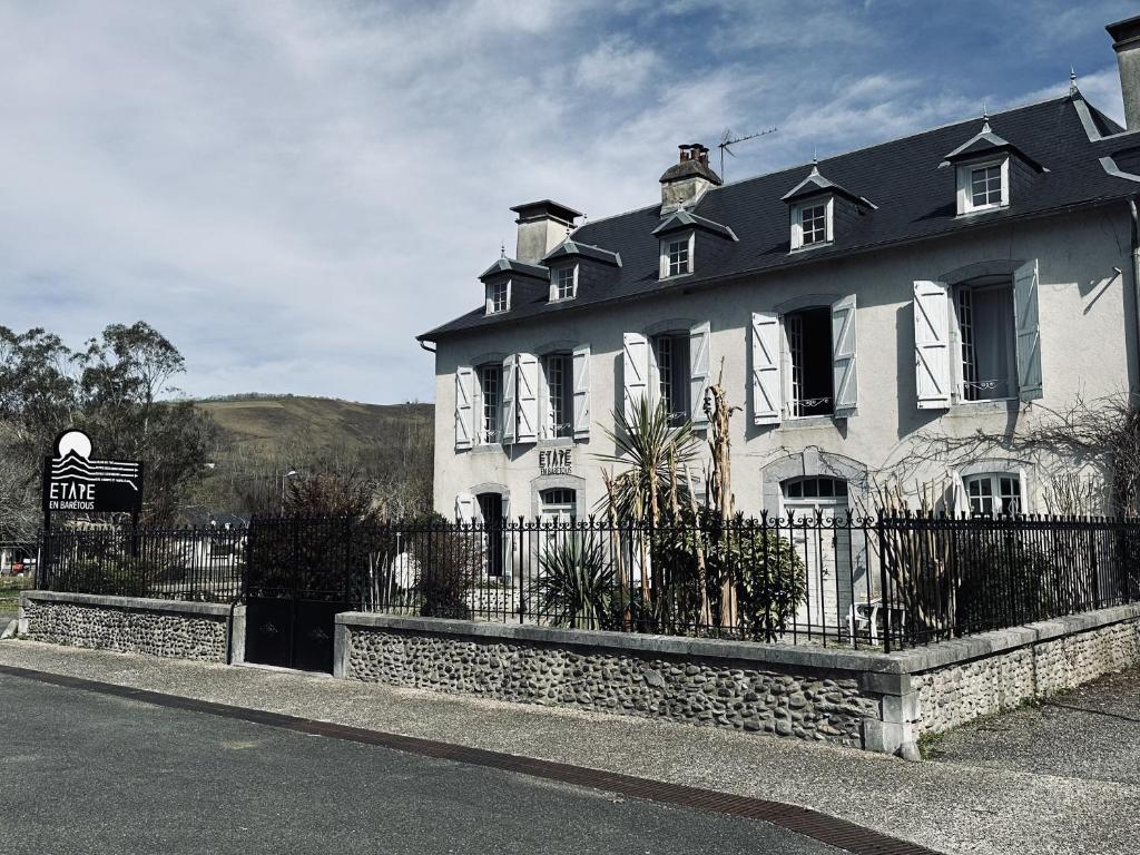 a large white house with a black roof at Etape en Barétous - 6 personnes in Aramits
