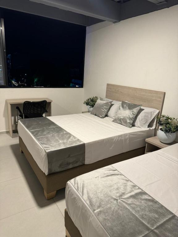Postel nebo postele na pokoji v ubytování Hotel Med Llanogrande
