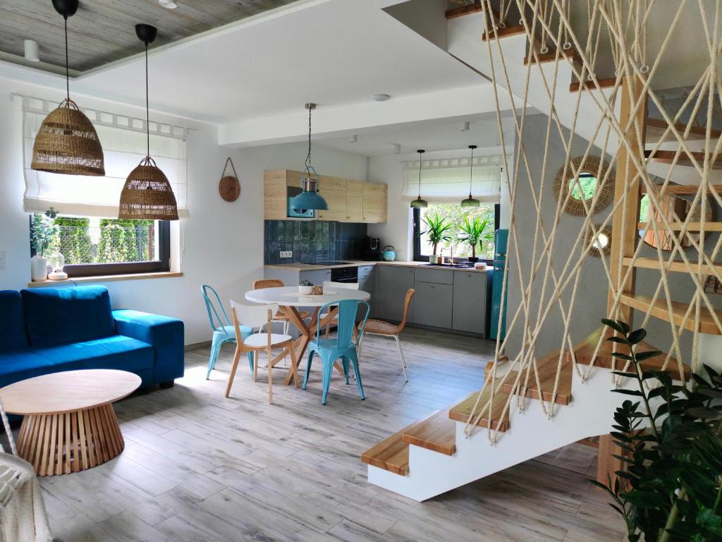 a living room with a blue couch and a table at Wyskocz w góry - domek z balią ogrodową in Szczyrk