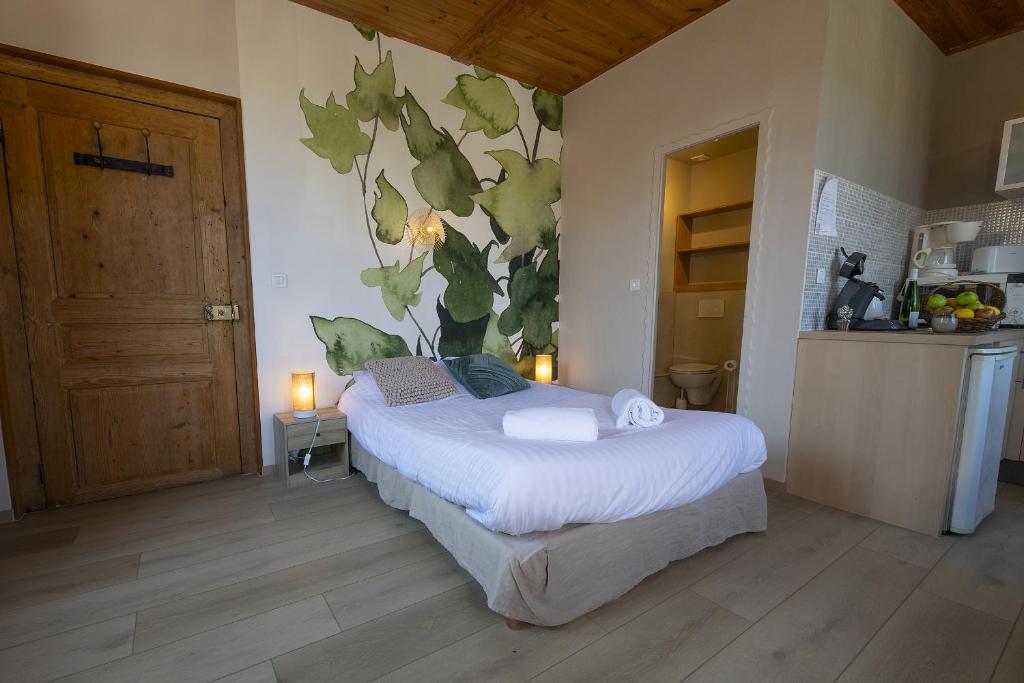 une chambre avec un lit avec un tableau sur le mur dans l'établissement GEWURZTRAMINER - Studio au pied du vignoble - rénové récemment - parking gratuit, à Riquewihr