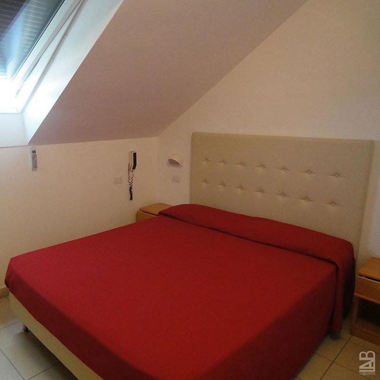 Postel nebo postele na pokoji v ubytování Hotel Matteo