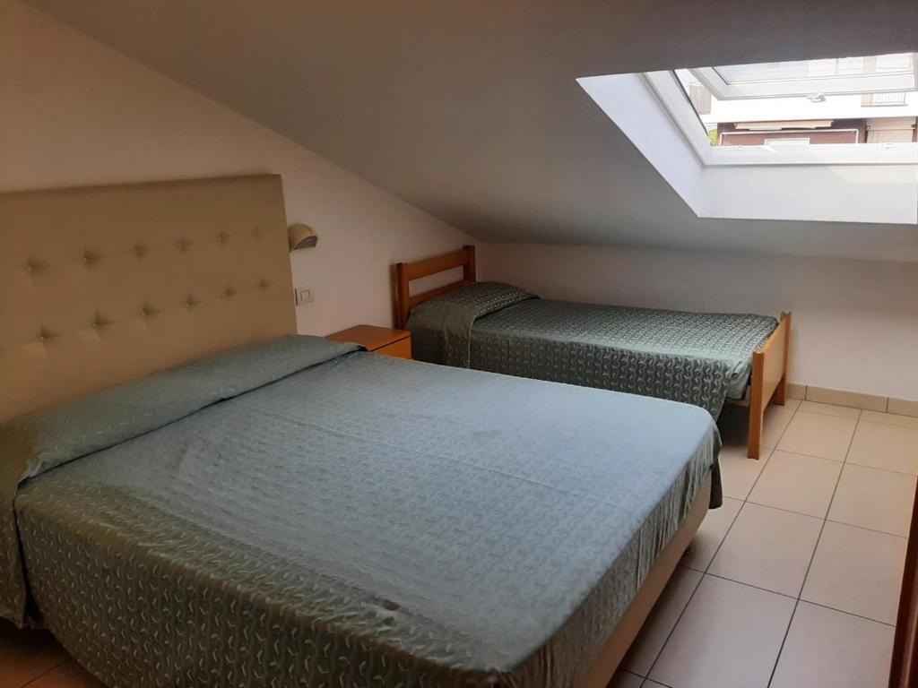 Postel nebo postele na pokoji v ubytování Hotel Matteo