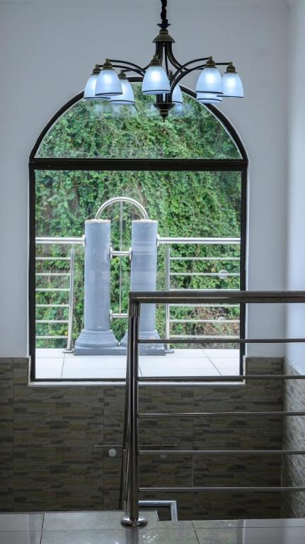 a light hanging over a table in front of a window at Green valley in Amanzimtoti