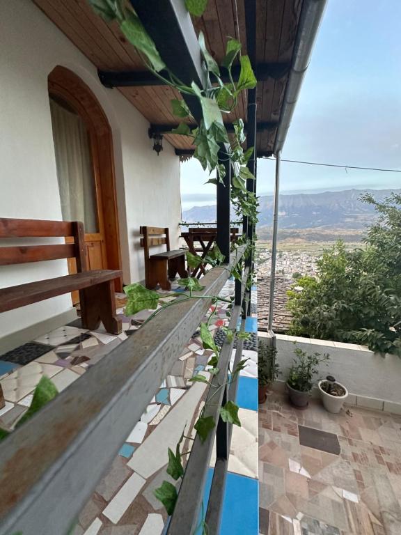a house with a balcony with a view of the mountains at Villa Zeko in Gjirokastër