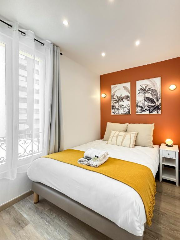 a bedroom with a large bed and a window at Villa Des Bégonias - PSG in Le Pré-Saint-Gervais