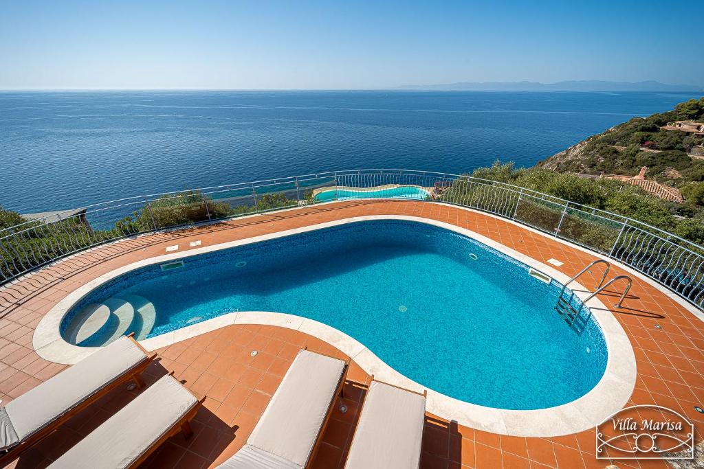 a swimming pool with a view of the ocean at Villa Marisa in Torre delle Stelle