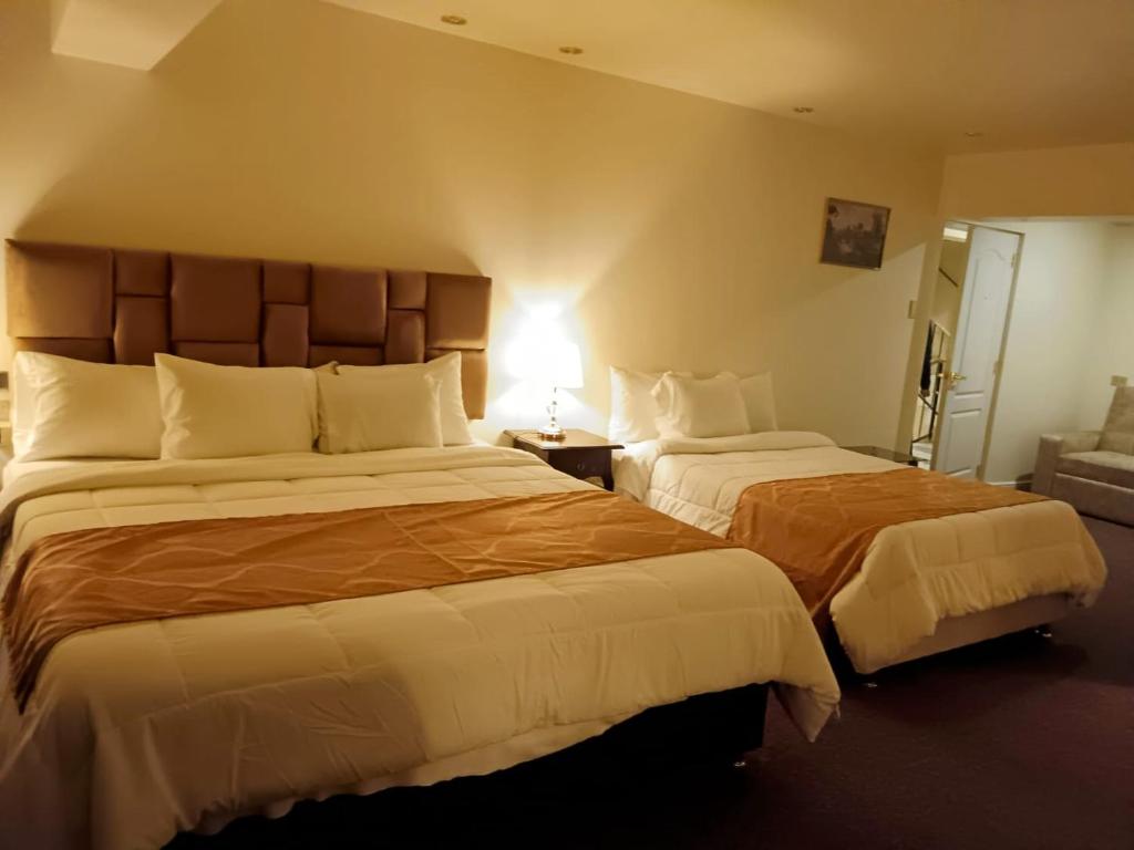 Postel nebo postele na pokoji v ubytování Hotel Paradis Suite Cusco