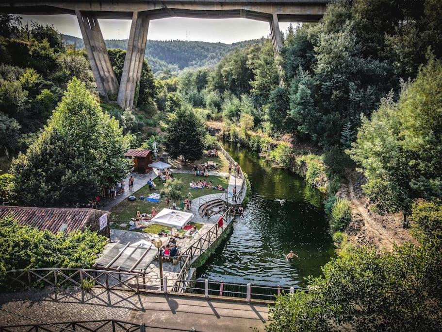 a view of a river with people swimming in it at Casa Mega Fundeira, natureza e praia fluvial in Pedrógão Grande