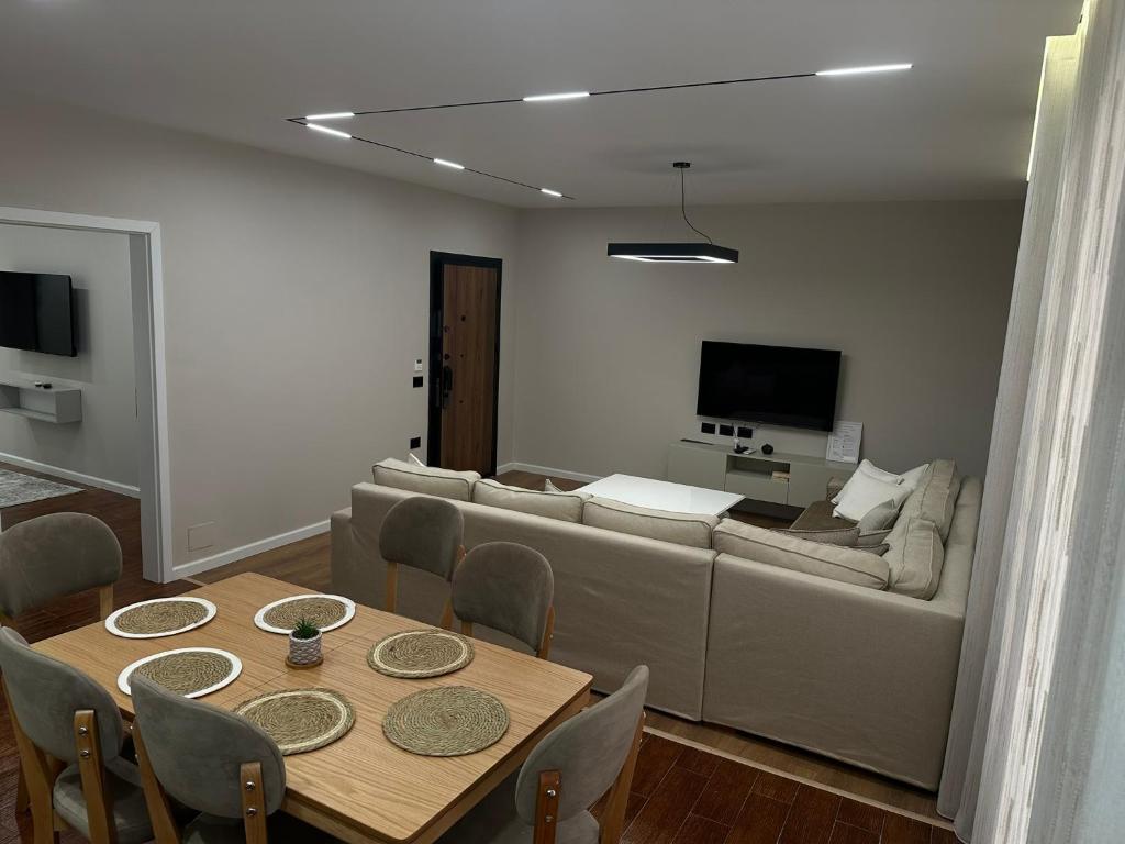 a living room with a couch and a table at Renev Apartments Tirana in Tirana