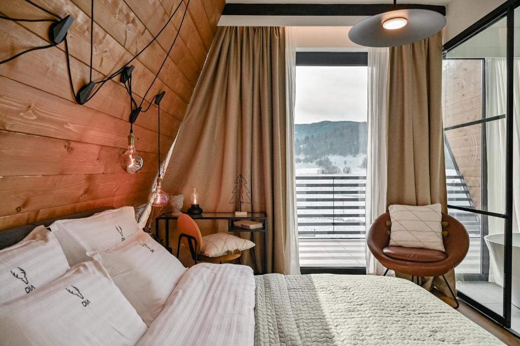 a bedroom with a bed and a large window at Villa Dia Sunger in Sunger
