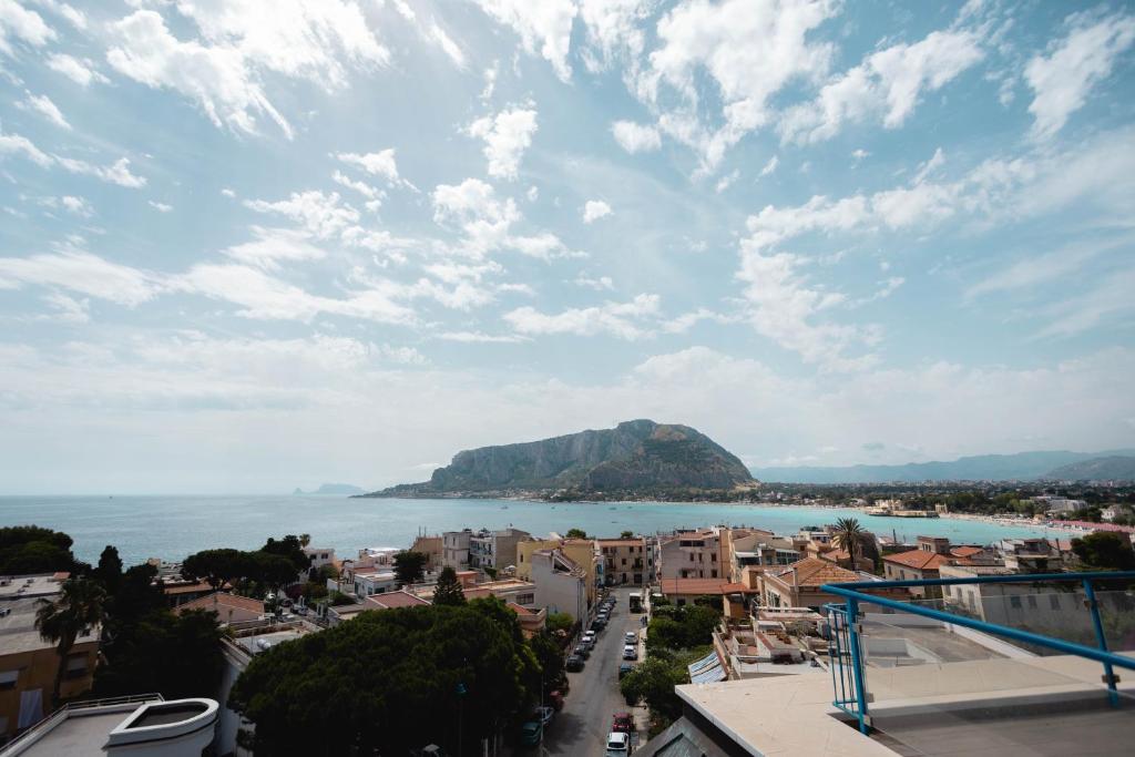 a view of a city and the ocean with a mountain at Mondello Glam Hotel & Terrace in Mondello