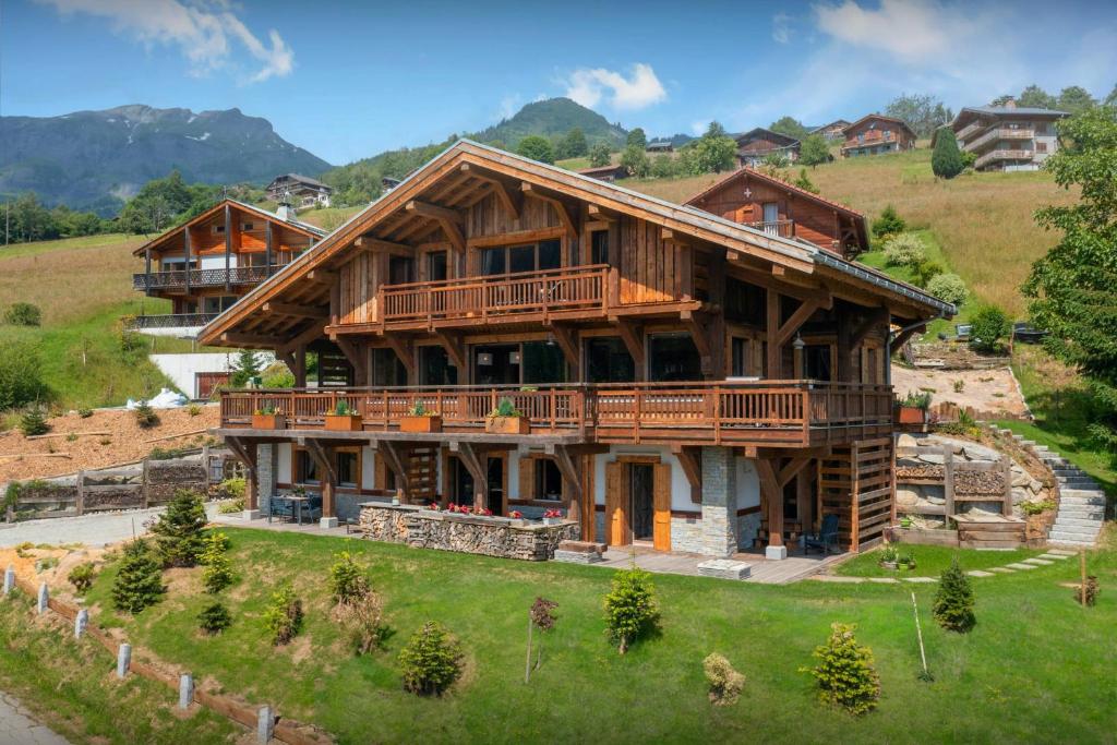 a large wooden house on top of a hill at Chalet K1027 - OVO Network in Cordon