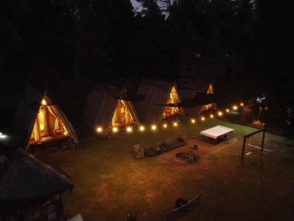 a group of tents with lights in the dark at LIL Ville Glamping by TLT in Dumaguete