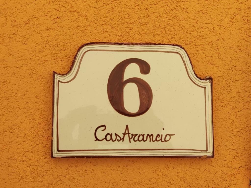 a sign on a wall with the number on it at CasArancio 6 in San Paolo Albanese