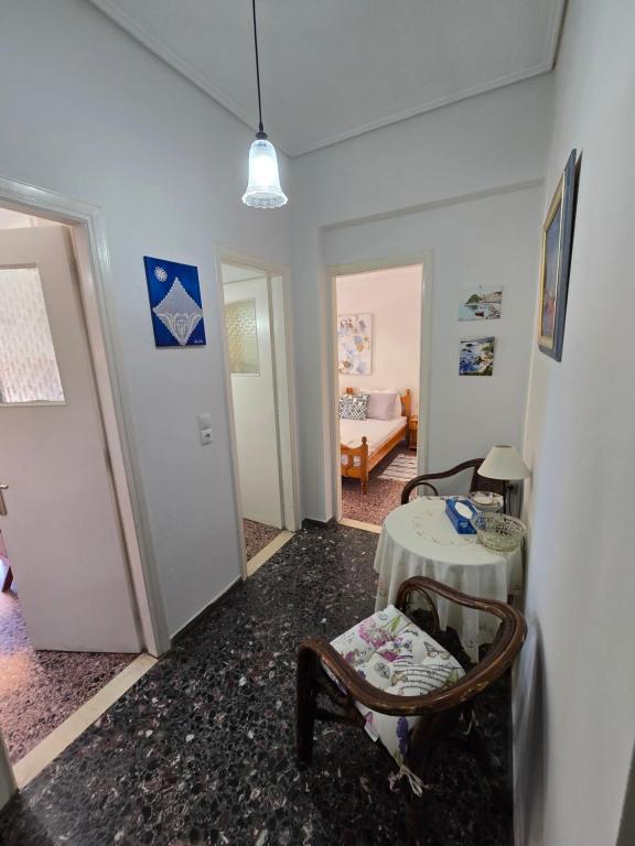 a living room with a table and a chair at loutraki apartment in Loutraki