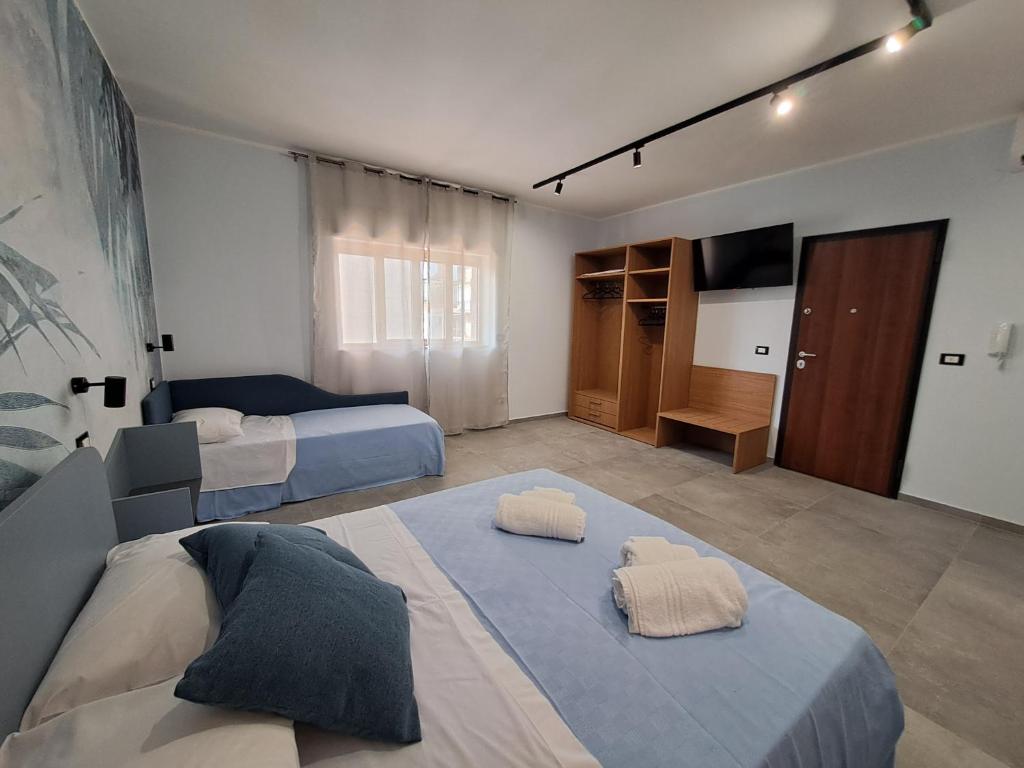 Postel nebo postele na pokoji v ubytování Azzurra Room
