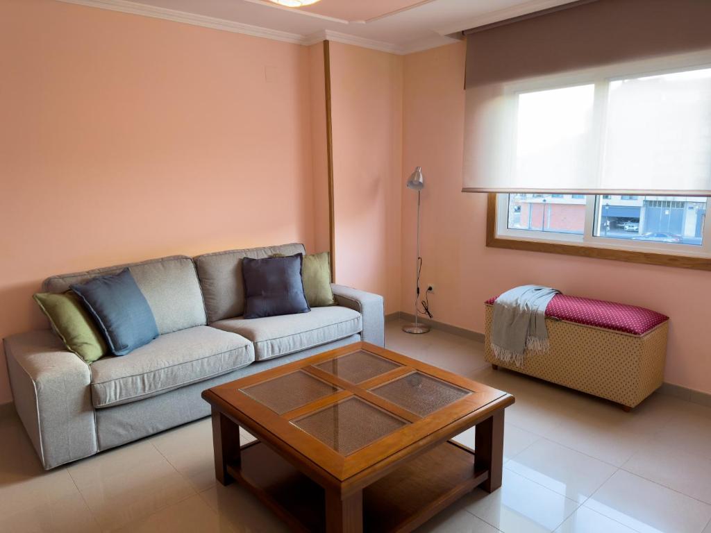 a living room with a couch and a coffee table at O Nido de Noe in Melide